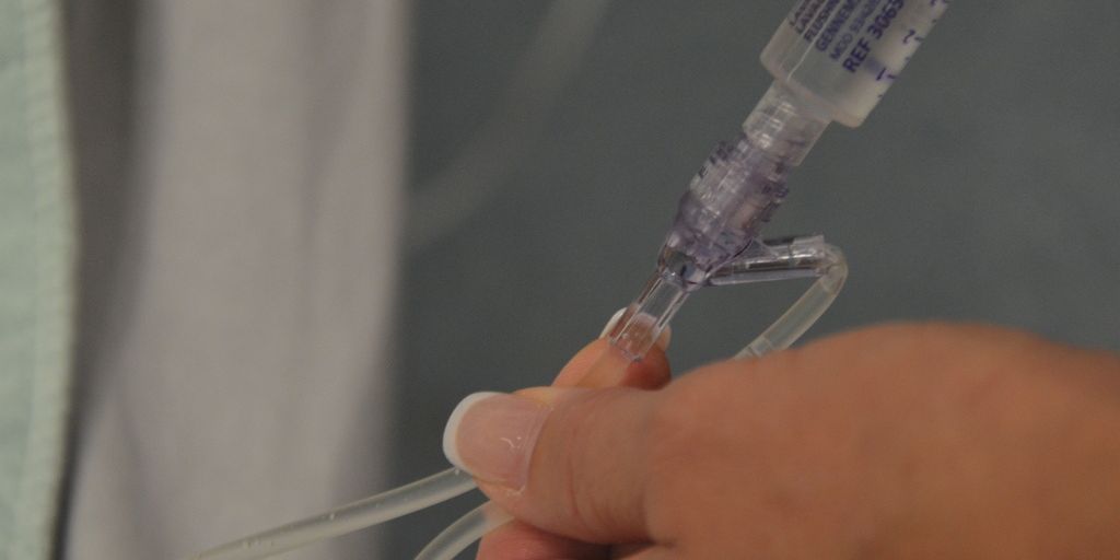 veterinarian applying antiseptic flush on dog in clinic