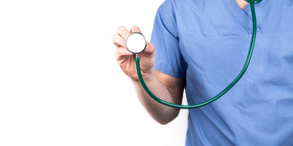 veterinarian examining dog with stethoscope in clinic